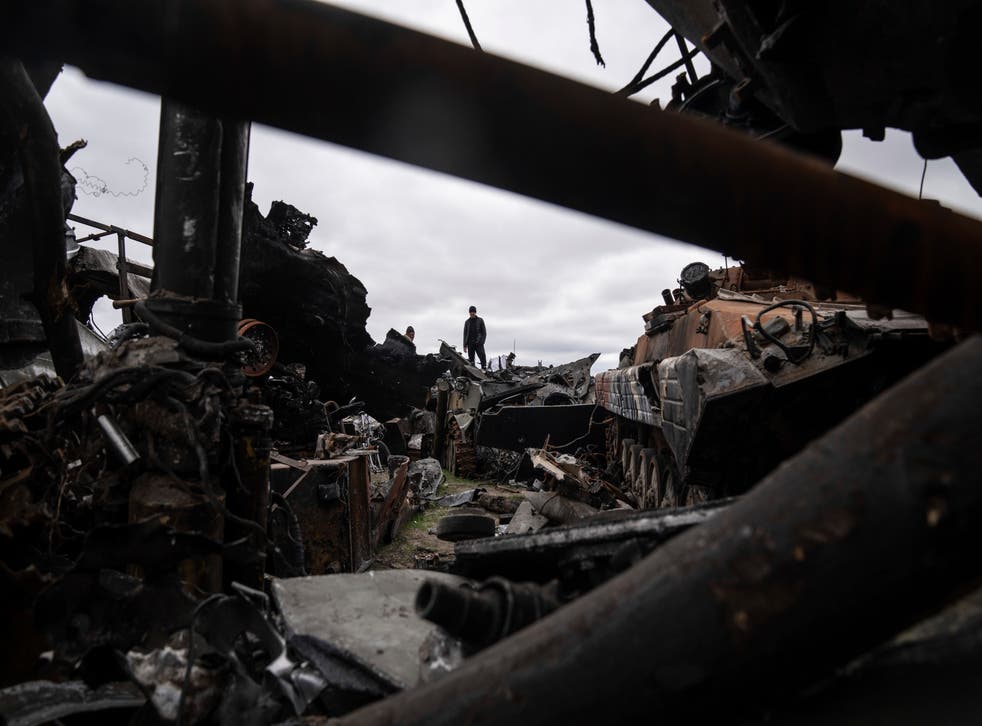 <p>A local man stands atop of destroyed Russian armoured vehicles in Bucha</s>