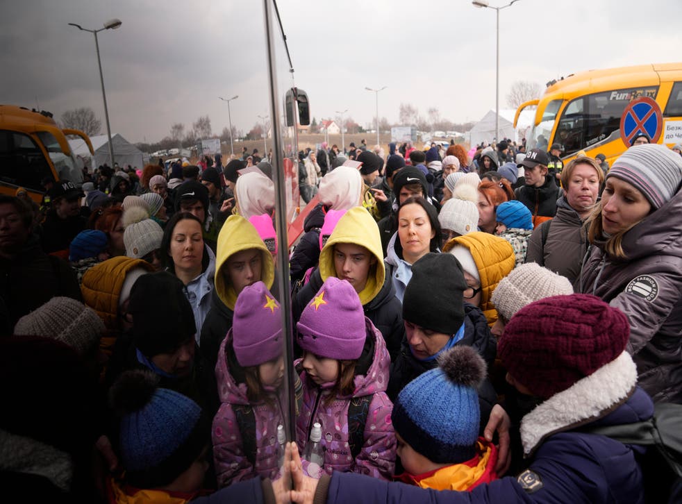People fleeing from Ukraine queue to board on a bus at the border crossing in Medyka, Poland. (AP Photo/Markus Schreiber, File)