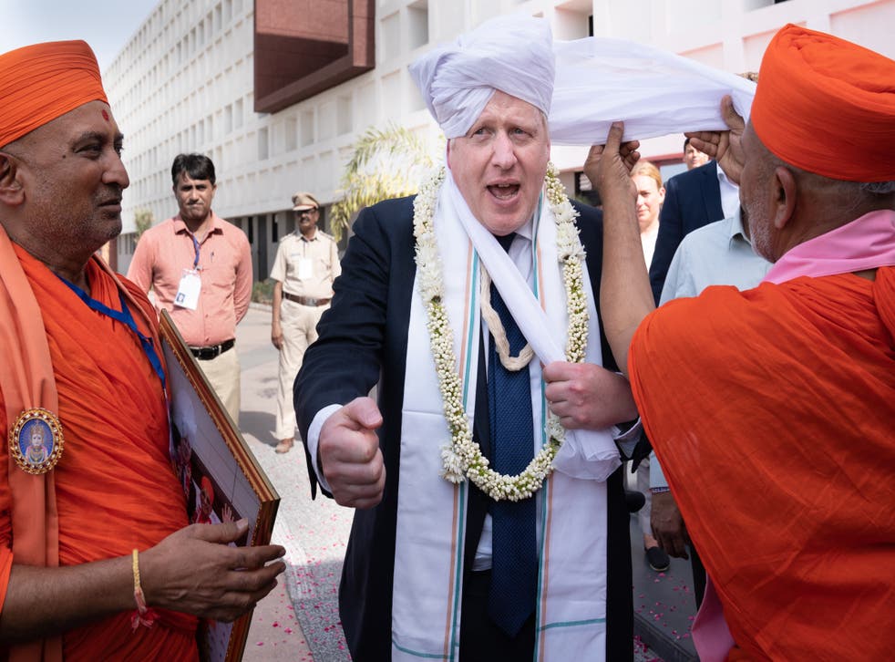 Boris Johnson missed the motion debate about his truthfulness because he is in India (Stefan Rousseau/PA)