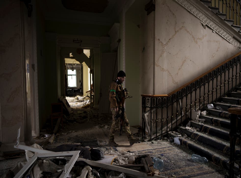 <p>A soldier walks inside the regional administration building in Kharkiv that was heavily damaged in a Russian attack</p>