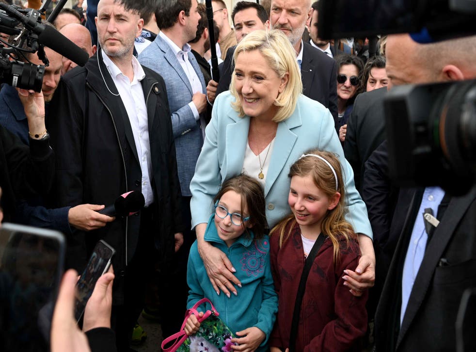 <p>Marine Le Pen poses for a picture with two girls during her visit in the coastal city of Berck</p>