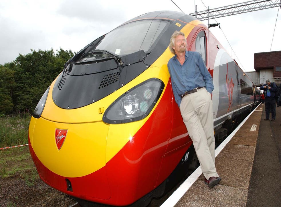 Virgin boss Sir Richard Branson with a Pendolino before the trains entered service in July 2002 (Myung Jung Kim/PA)