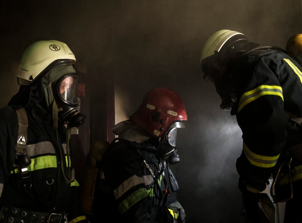 Firefighters work to extinguish a fire in an apartment following a Russian bombardment in Kharkiv, Ukraine (Felipe Dana/AP)