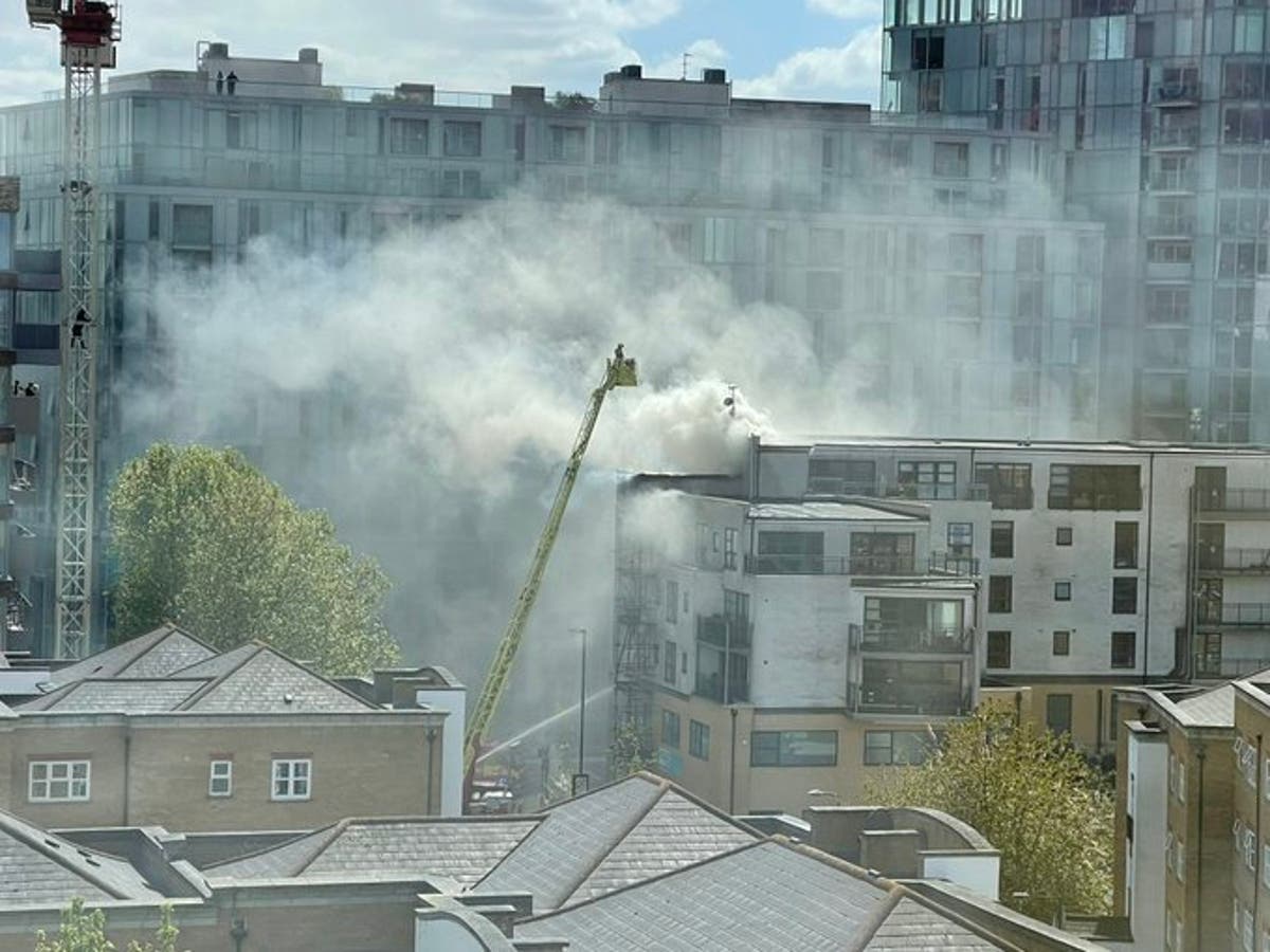 Deptford: 100 firefighters battling blaze on roof of London flats