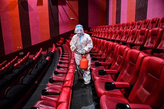 A staff member sprays disinfectant at a cinema as the city starts to reopen after a Covid-19 coronavirus outbreak in Shenyang, in China's northeastern Liaoning province