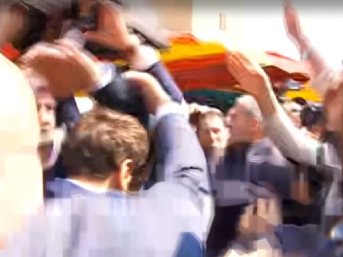 Protester throws tomatoes at Emmanuel Macron during Paris walkabout