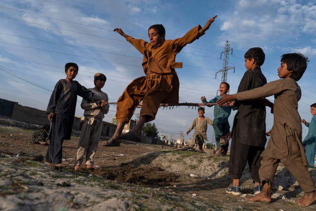 Afghan children play in a field in Kabul