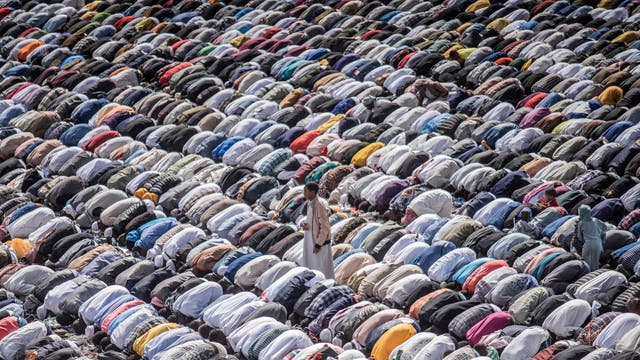 Muslim worshippers pray during the Eid al-Fitr morning prayer sermon at a football stadium in Addis Ababa, Ethiopia, as Muslims across the globe mark the end of the Holy month of Ramadan
