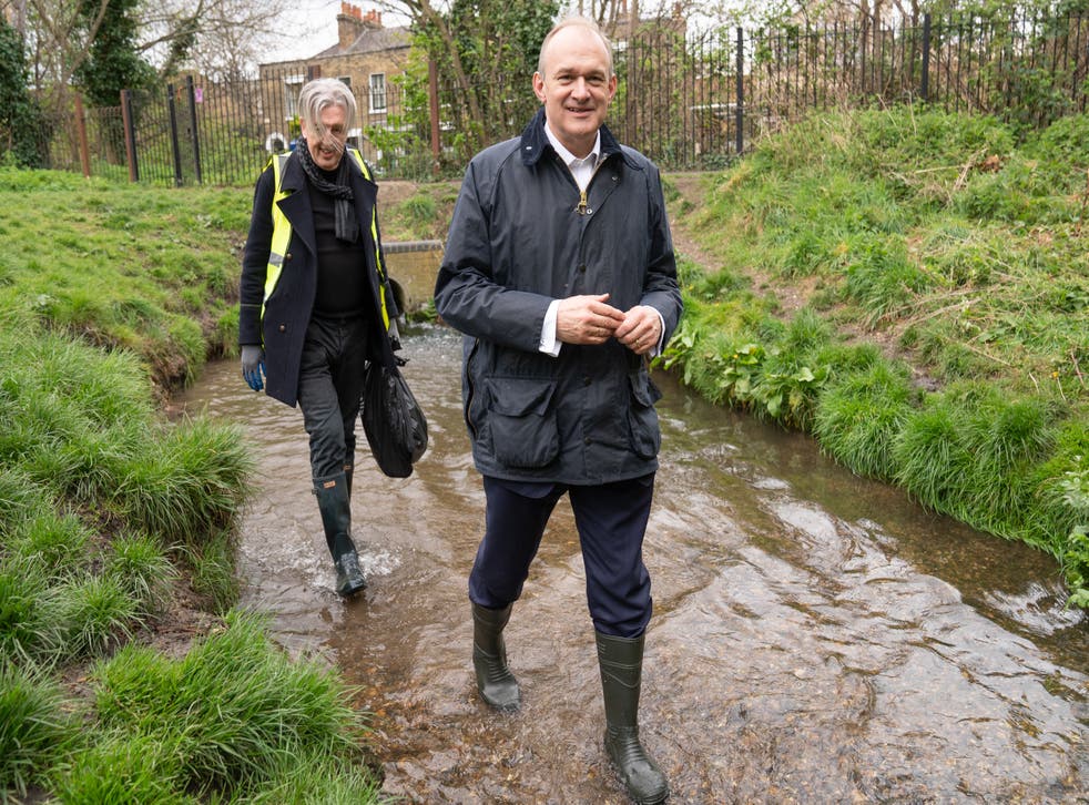 Leader of the Liberal Democrats Sir Ed Davey helps to clear rubbish from the River Wandle in south-west London while on the campaign trail (Stefan Rousseau / PA)