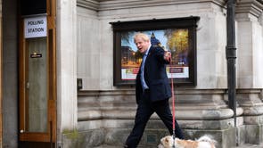 British Prime Minister Boris Johnson arrives at a polling station with his dog Dilyn to vote during local elections in Westminster, London