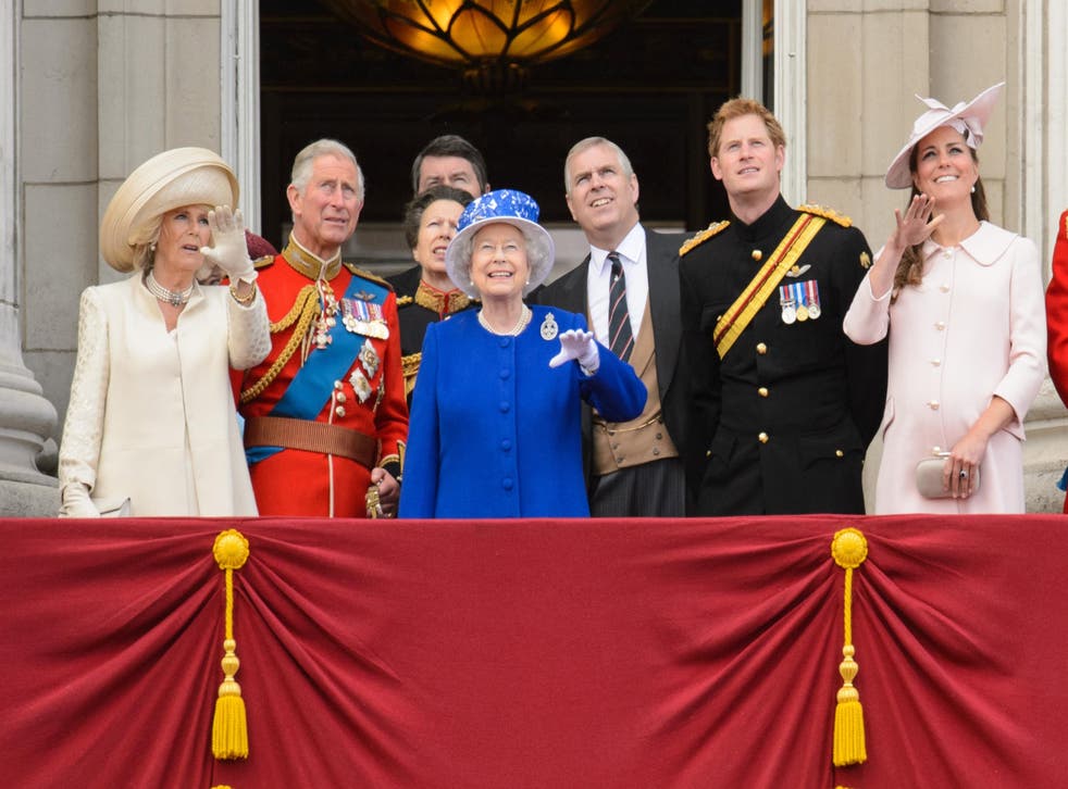 The Duke of York next to his mother on the balcony of Buckingham Palace in 2013 (PA)