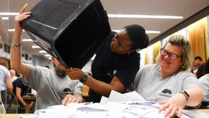 Ballots are emptied from a ballot box to be counted, during local elections, at Wandsworth Town Hall, London