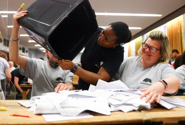 Ballots are emptied from a ballot box to be counted, during local elections, at Wandsworth Town Hall, Londres
