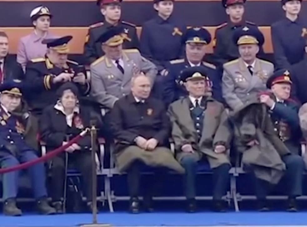 <p>Putin is the only person present who is using a blanket for warmth </p>