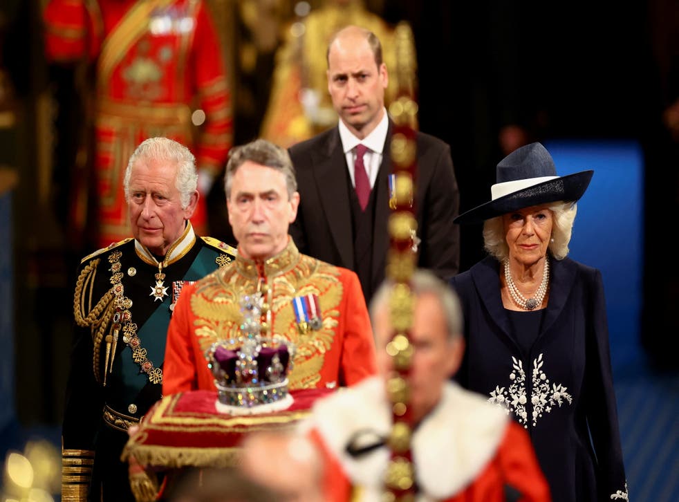 The Prince of Wales and the Duchess of Cornwall, with the Duke of Cambridge, back centre, proceed behind the Imperial State Crown through the Royal Gallery during the State Opening of Parliament (Hannah McKay/PA)