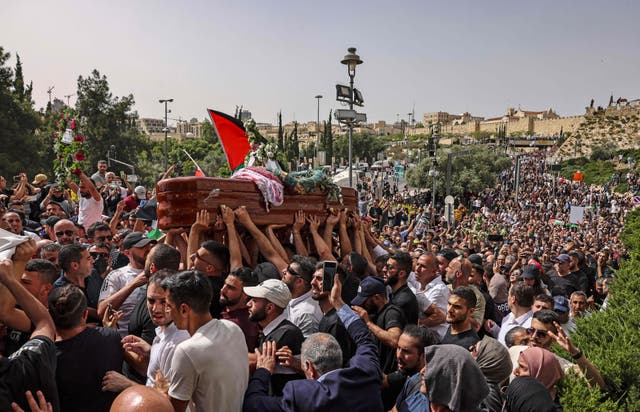 Palestinian mourners carry the casket of slain  Al-Jazeera journalist Shireen Abu Aklel, during her funeral procession from the church toward the cemetary, in Jerusalem