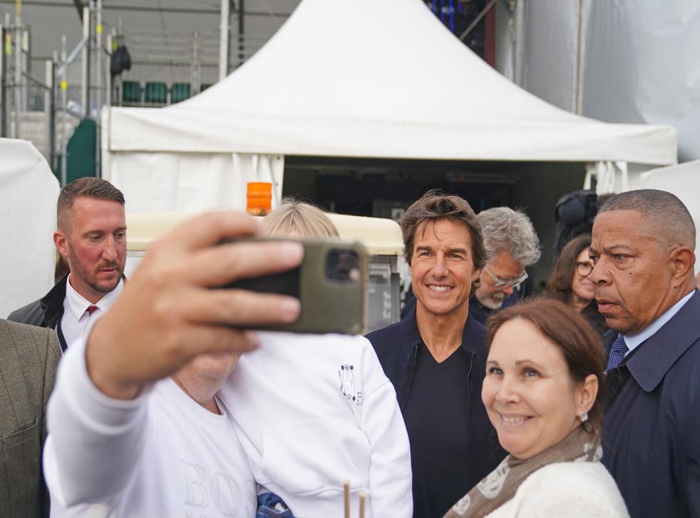 Tom Cruise poses for a selfie ahead of the show honouring the Queen (Steve Parsons/AP)