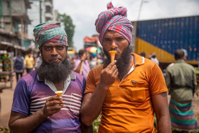 Day laborers eat ice-cream during a hot summer day in Dhaka, Bangladesj