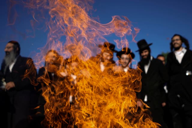 Ultra Orthodox Jews dance around a bonfire during Lag BaOmer celebrations at the traditional grave site of Rabbi Shimon Bar Yochai at Mount Meron, northern Israel
