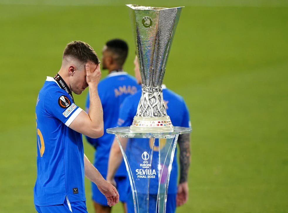 Rangers’ Aaron Ramsey walks past the Europa League trophy after missing the decisive spot-kick in Wednesday’s final shoot-out against Eintracht Frankfurt (Andrew Milligan/PA)