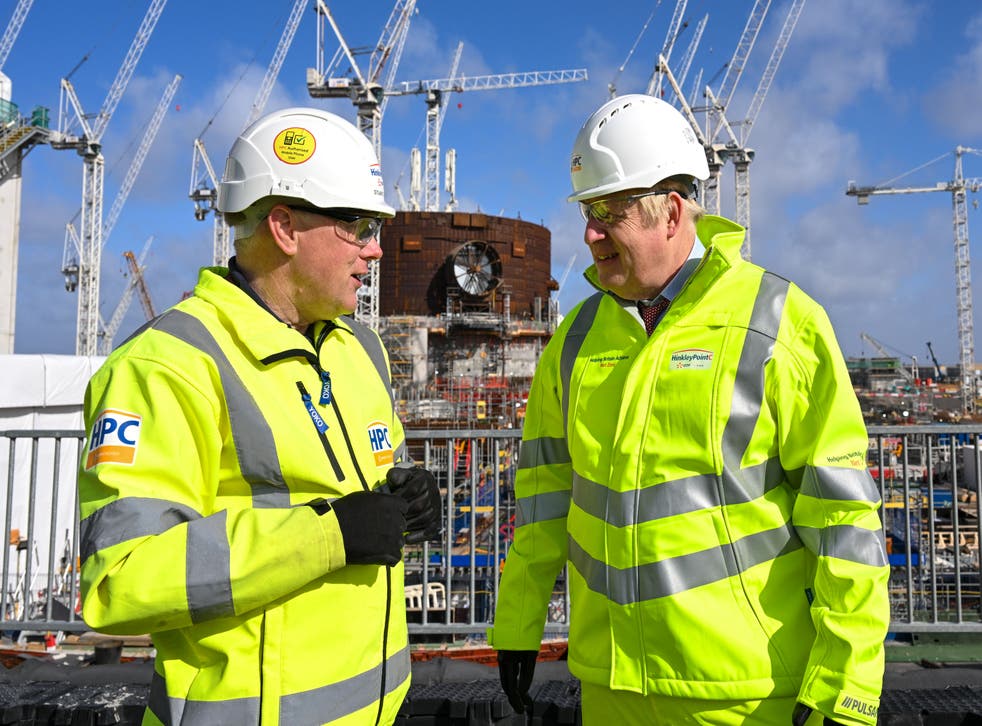Prime Minister Boris Johnson, with Stuart Crooks, managing director of Hinkley Point C, during a visit to Hinkley Point C nuclear power station construction site in Somerset on April 7, 2022 (Finnbarr Webster/PA)