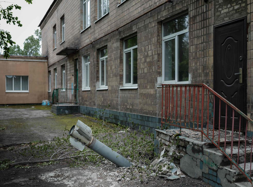 <p>An unexploded ordnance is seen at a backdoor of a kindergarten where seven people have been sheltering in the basement for more than two months, in Lysychansk, eastern Ukraine</p>