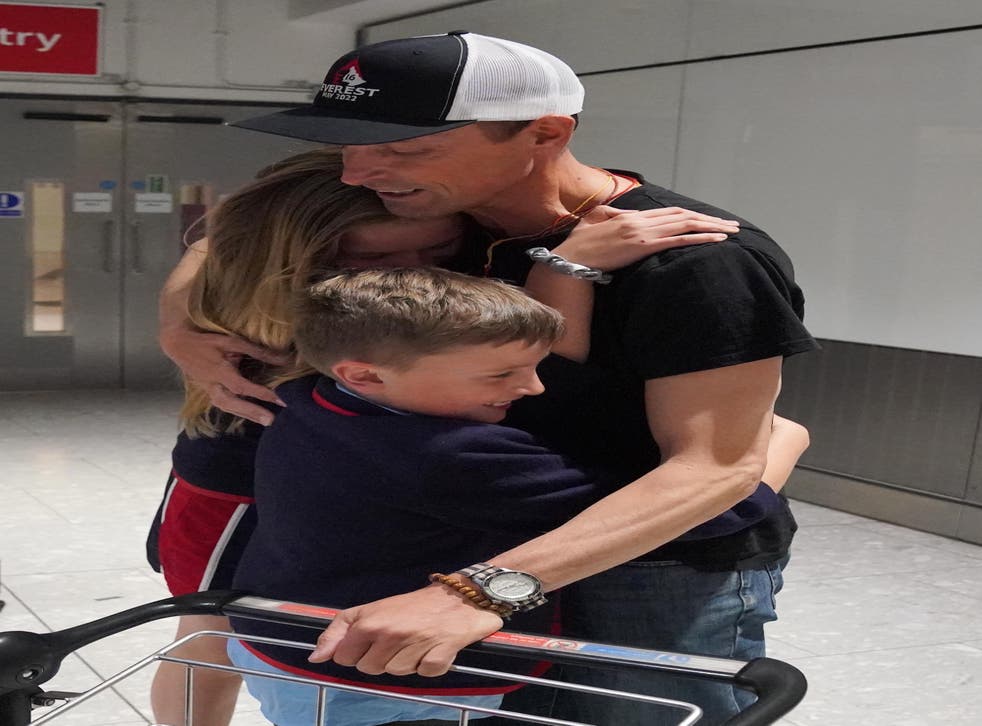 Kenton Cool was embraced by daughter Saffron and son Willoughby at Heathrow Airport (Jonathan Brady/PA)