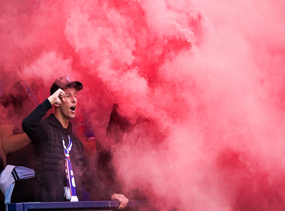 Rangers fans celebrate with flares during their Scottish Cup final victory against Hearts (Andrew Milligan/PA)