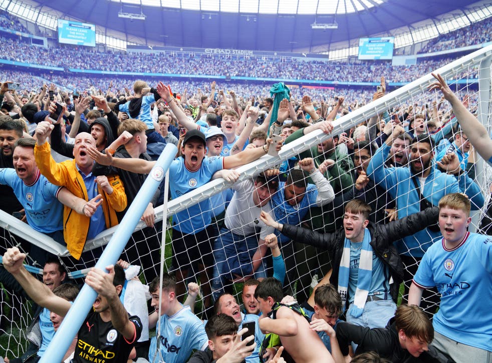 Manchester City fans invade the pitch and break the goal (Martin Rickett / PA)