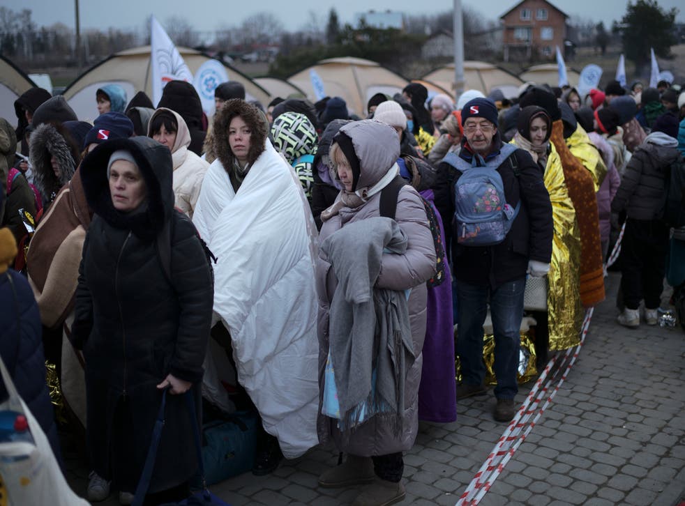 <p>Refugees waitingg in a crowd for transportation after fleeing from the Ukraine and arriving at the border crossing in Medyka, Poland in March </bl>
