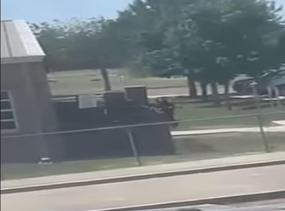 <p>An eerie video was posted on social media on the day of the Uvalde shooting, which shows the gunman tracing the perimeter of the elementary school, rifle in hand, before he would go onto break-in and barricade a classroom full of students and two teachers and open fire.</磷>