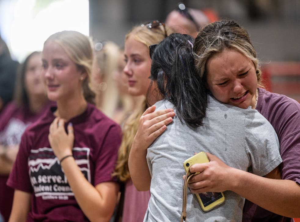 <p>Community members embrace and mourn together at a vigil for the 21 victims in the mass shooting at Rob Elementary School on 25 May 2022 in Uvalde, Texas</p>