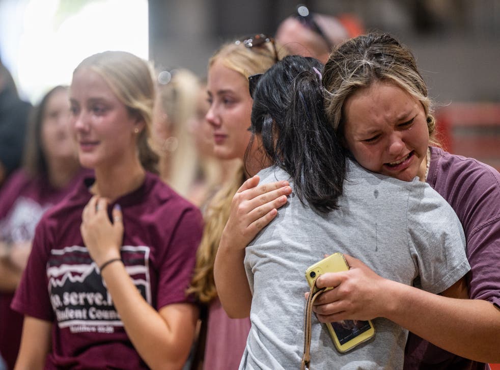 <p>Community members embrace and mourn together at a vigil for the 21 victims in the mass shooting at Rob Elementary School on 25 可能 2022 in Uvalde, 德克磷斯州</p>