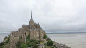 This aerial view shows French tightrope walker Nathan Paulin walking on a slackline close to Le Mont Saint-Michel abbey, north-western France