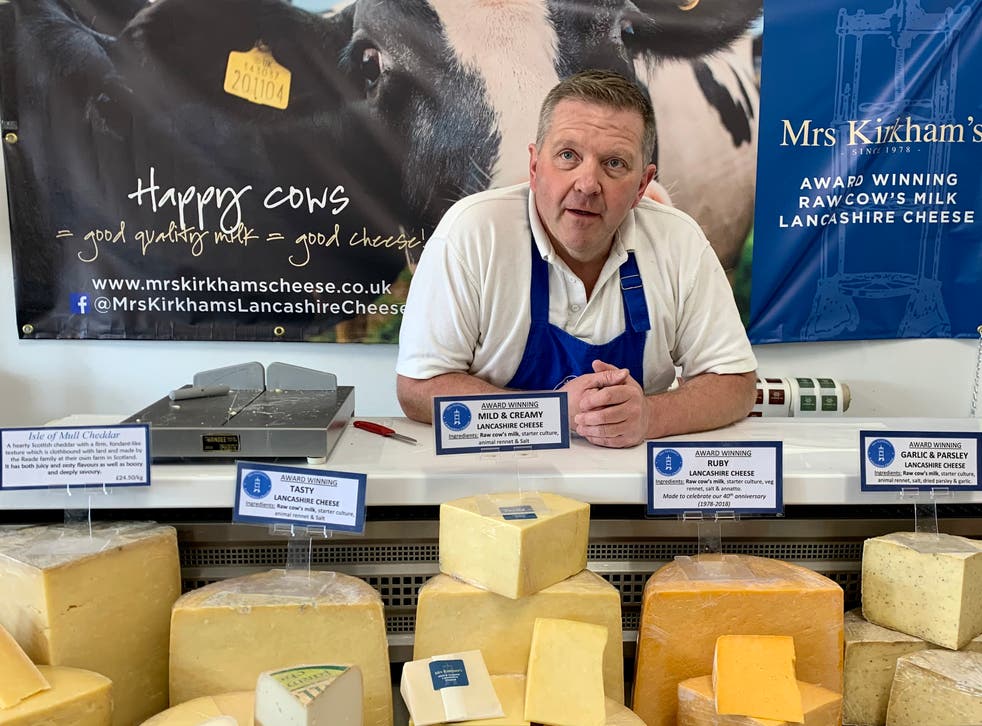 <p>Graham Kirkham with his Lancashire cheeses, the county's last unpasteurised ones</p>