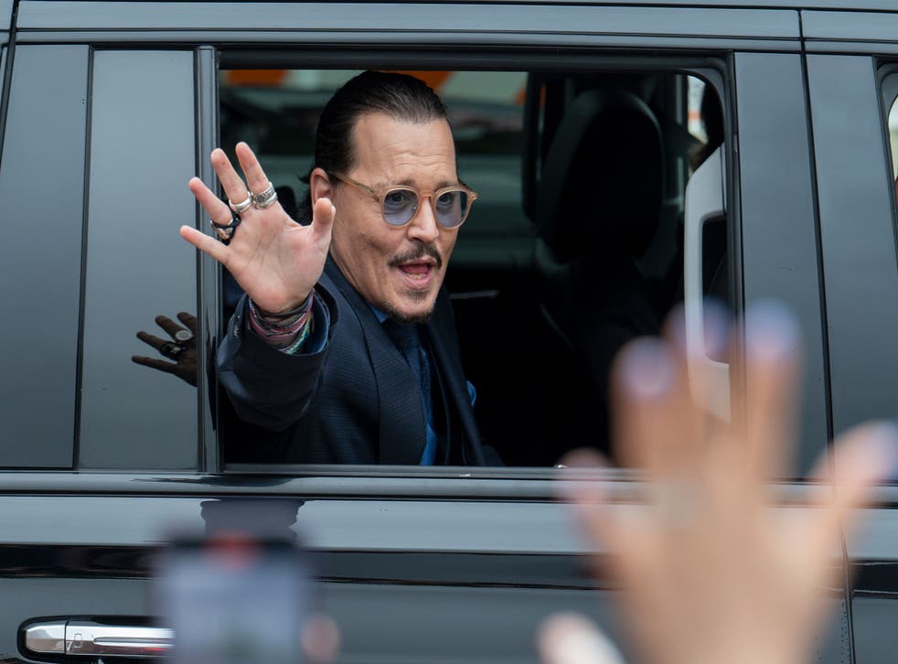 Johnny Depp waves to supporters as he departs the Fairfax County Courthouse on Friday (Craig Hudson/AP)