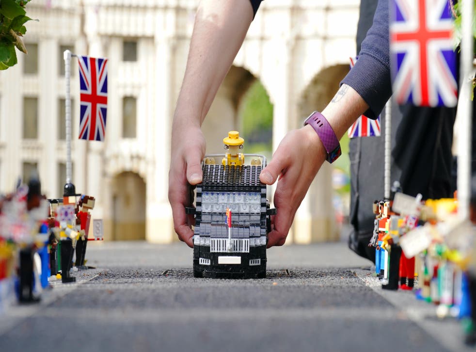 Lego spectators watch as the Queen model travels down The Mall (Jonathan Brady/PA)