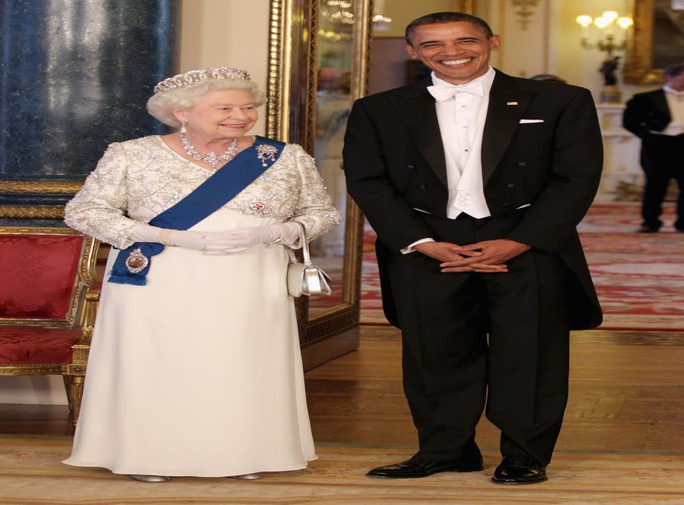 The Queen, in a tiara and evening gown, with then US president Barack Obama at a state banquet (Chris Jackson/PA)