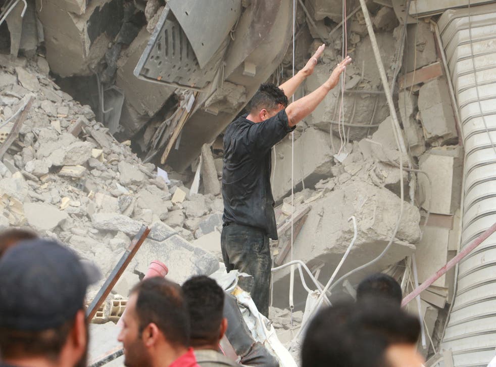 <p> Iranians gather as rescue crews work at the site of the collapsed building</p>