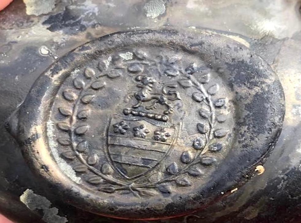 The crest of the Legge family – ancestors of George Washington, the first US President – was found on a bottle with the wreck. (Norfolk Historic Shipwrecks/ PA)