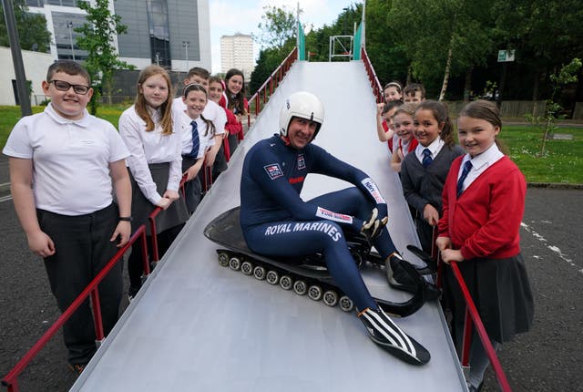 Pupils with Petty Officer Tommy O'Toole from the Royal Navy with the world's first mobile luge ramp, designed and manufactured by engineering students at Glasgow Caledonian University with the help of pupils from six Renfrewshire primary schools