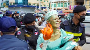 Cambodian-US human rights advocate Theary Seng, dressed as Lady Liberty, is arrested by police after being found guilty of treason in her trial in front of the Phnom Penh municipal court