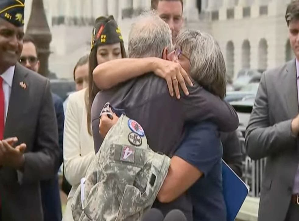 <p>Jon Stewart and Susan Zeier, mother-in-law of late Sgt First Class Heath Robinson, share an emotional moment after the bill’s passage </p>