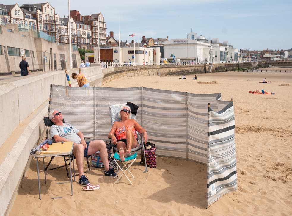 <p>People sunbathe as they enjoy the hot weather on Bridlington beach on the Yorkshire coast</bl>