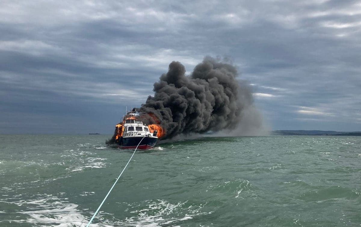 Two rescued after motor cruiser catches fire and sinks