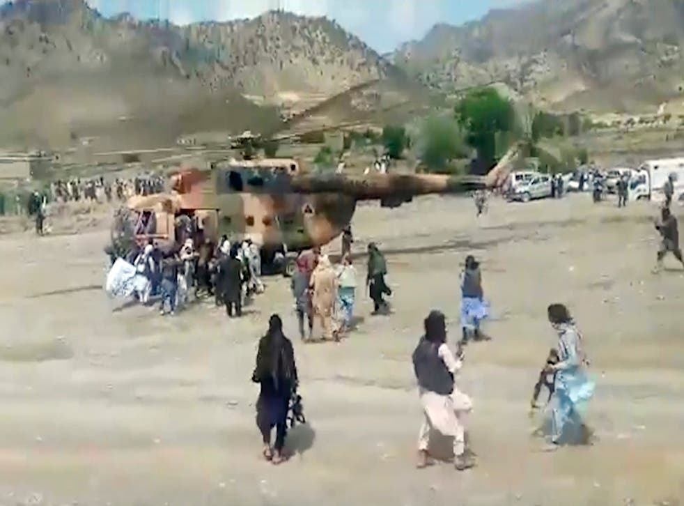 <p>Taliban fighters secure a government helicopter to evacuate injured people in Gayan district, Paktika province, Afghanistan</p>