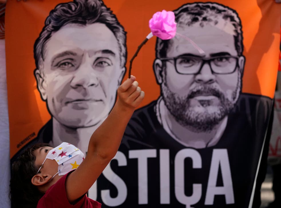 <p>A banner with images of Phillips (links) and Bruno Pereira and the word ‘Justice’ written in Portuguese, during a rally demanding authorities conduct a thorough investigation into the circumstances leading to their deaths, in Brasilia on 19 Junie&ltbl/p>