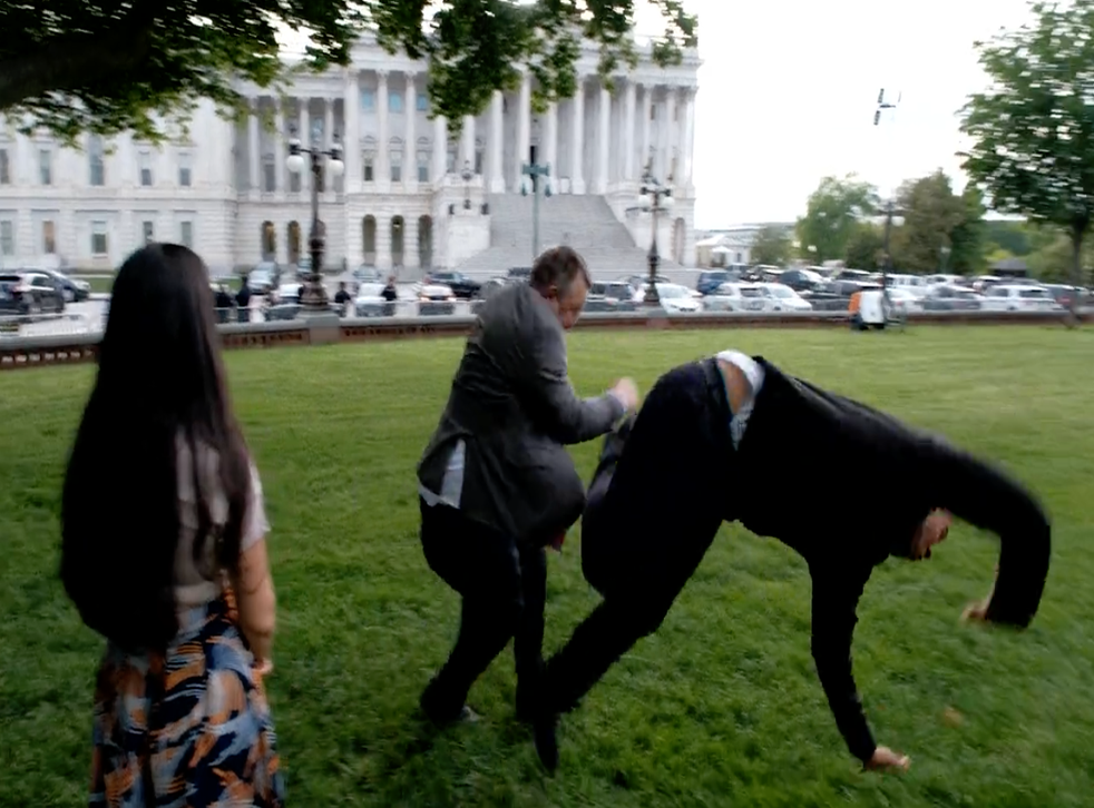 <p>Senator Jon Tester is seen jokingly tackling Senator Cory Booker in a recent political ad</p>