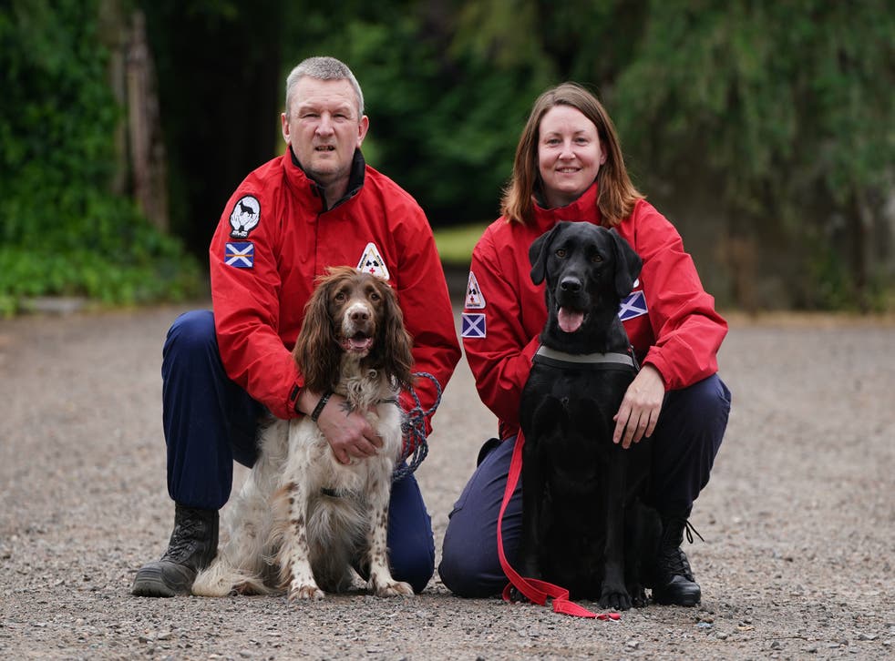 John Miskelly with his dog Bracken alongside team member Emma Dryburgh and her dog Dougal at his home in Falkland, Fife (Andrew Milligan/PA)
