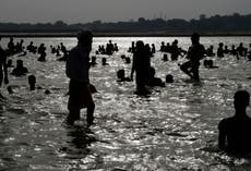 Man hit and dragged out of holy river for kissing partner while bathing in India